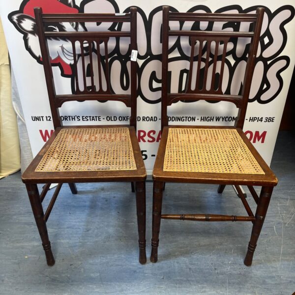Vintage Edwardian chairs with dark wood frames and woven seats.