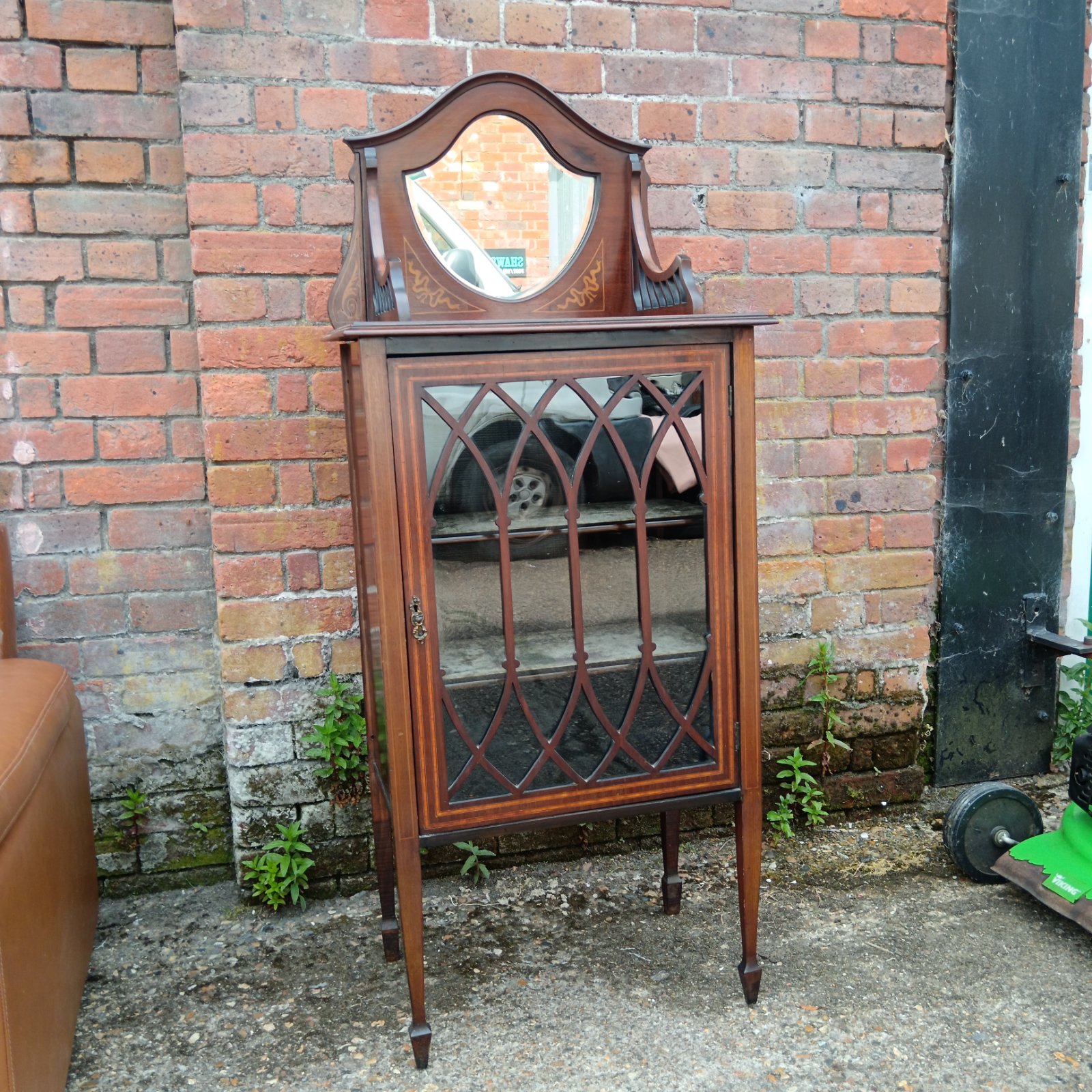 Edwardian mahogany display cabinet with satinwood inlay and arched mirror.