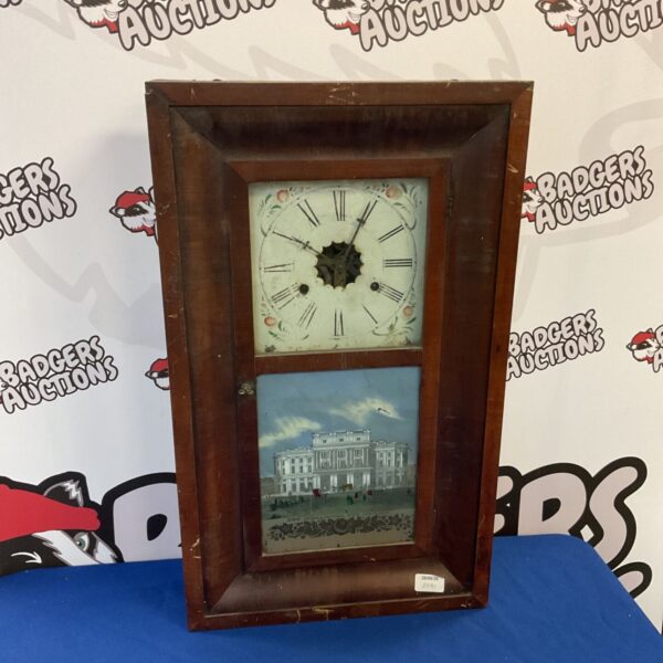 Antique E N Welch wall clock with glass front and lithograph.