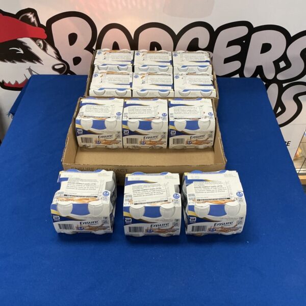 Stack of 48 sealed Ensure Compact Cafe Latte bottles.