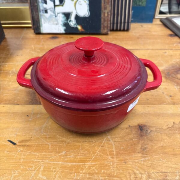 Red cast iron casserole pot by Ernesto with lid and handles.