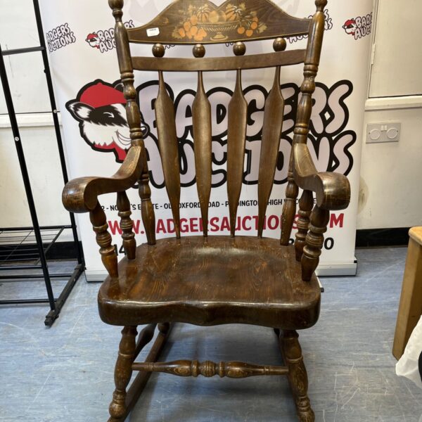 Vintage farmhouse rocking chair with painted fruit detail.