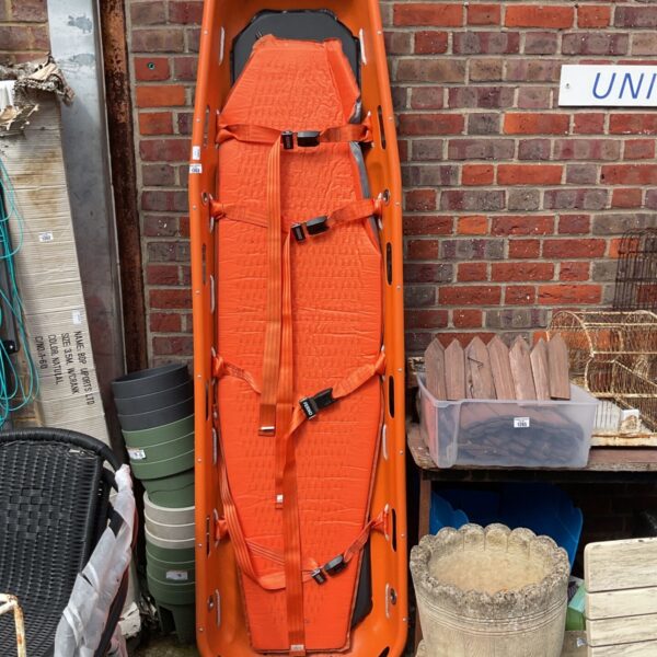 Orange Ferno model 71 basket stretcher for emergency medical use.