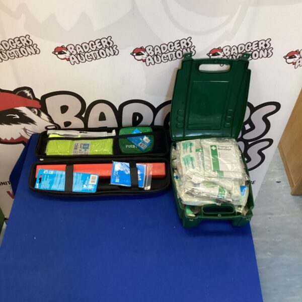 Green first aid kit with breakdown safety items visible inside.