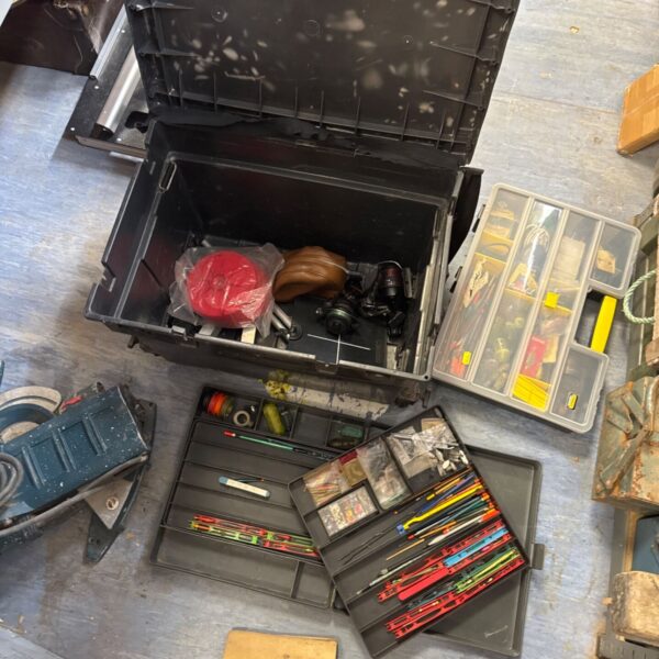 Open fishing tackle seat box with assorted fishing gear inside.
