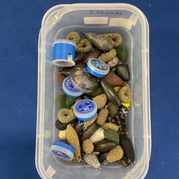 Tub of assorted fishing weights for angling and tackle.
