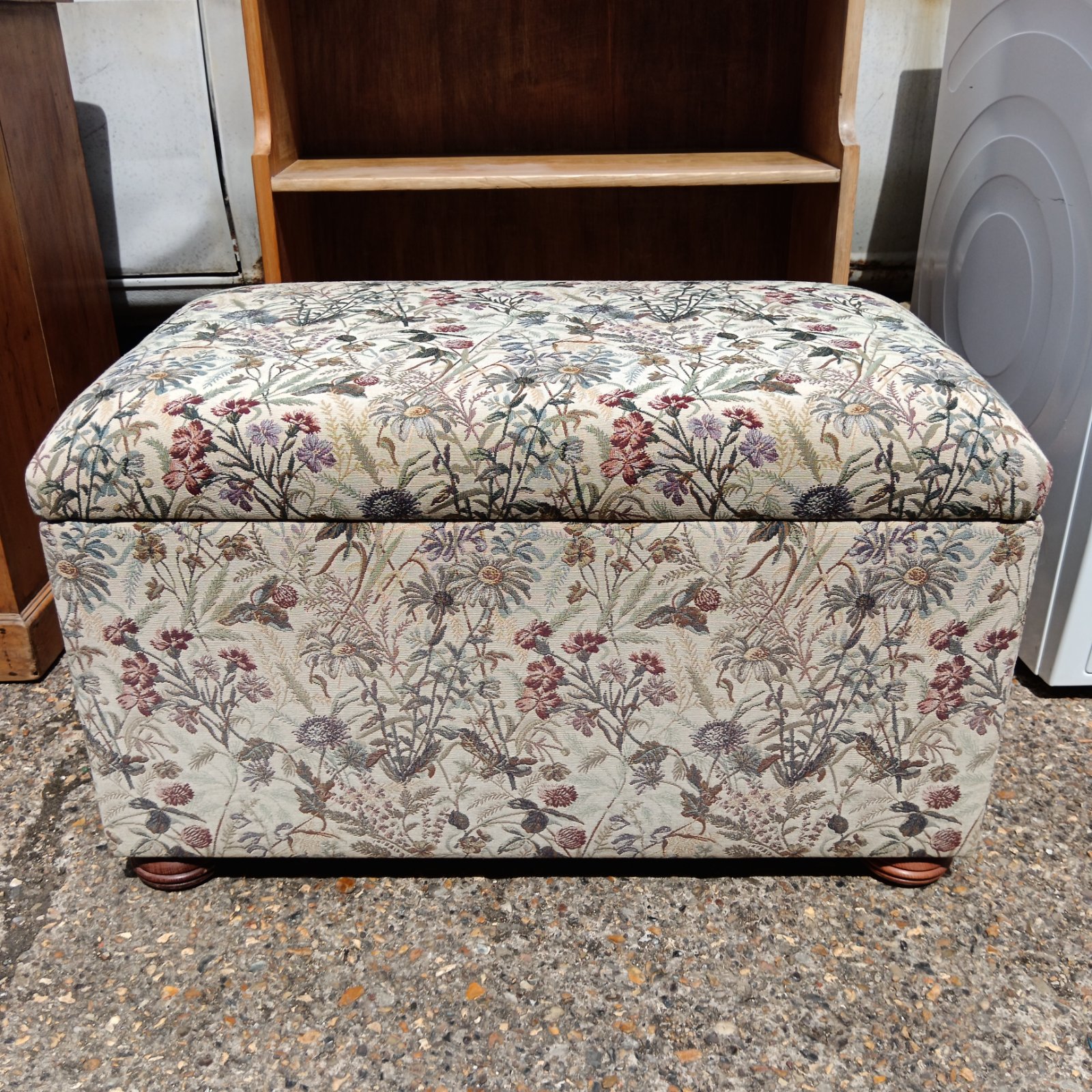 Front view of a floral ottoman storage bench.
