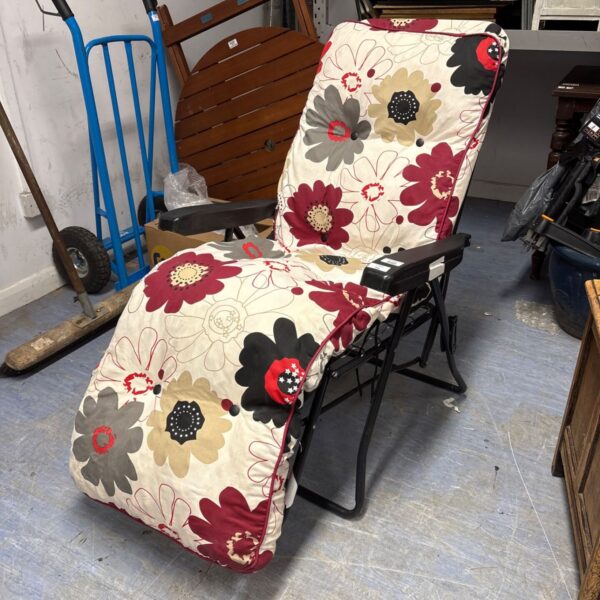 Vibrant floral reclining garden chair for outdoor relaxation.