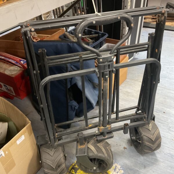 Side view of a folding fishing cart with large tires.