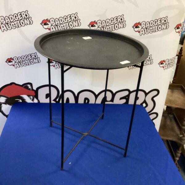 Vintage metal folding table, ideal for portable use.