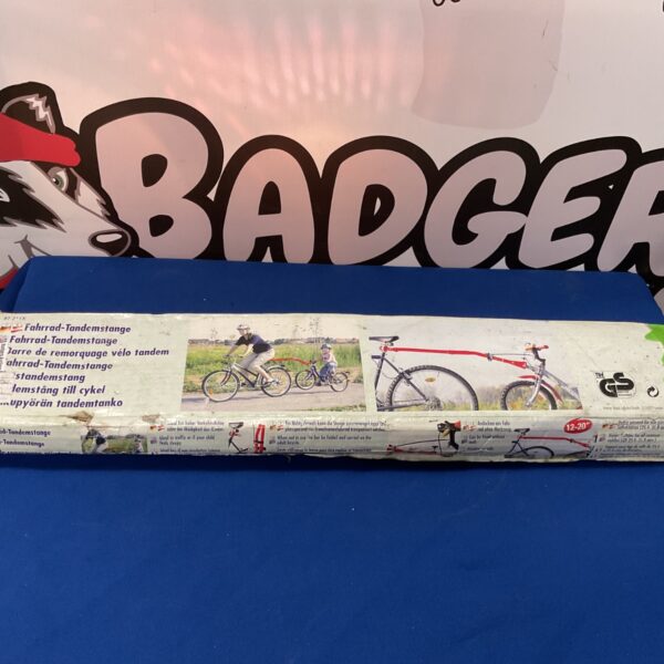 Folding tandem bike trailer for children attached to a bicycle.
