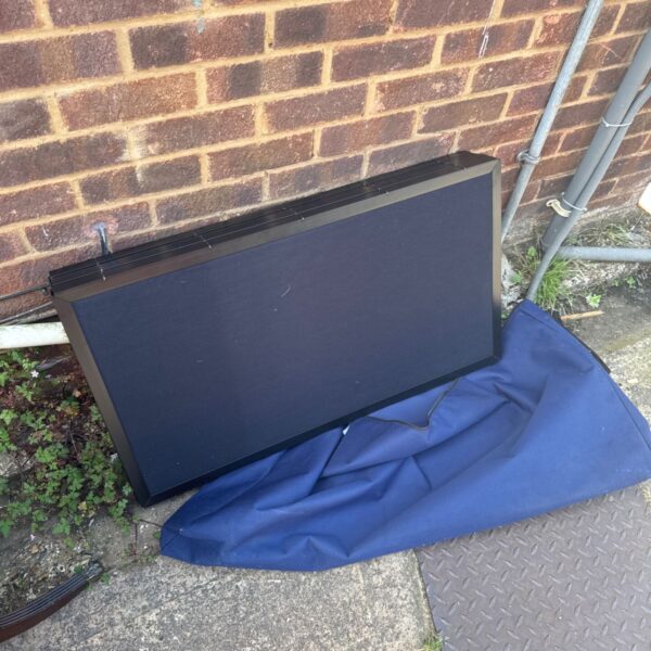 Black folding workspace divider in a carry bag.
