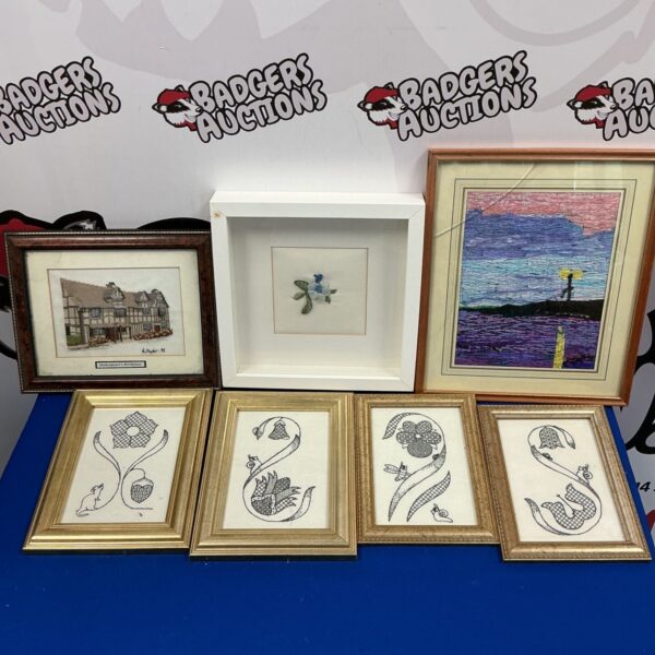 Framed embroidery collection featuring Shakespeare's Birthplace and vintage needlework.