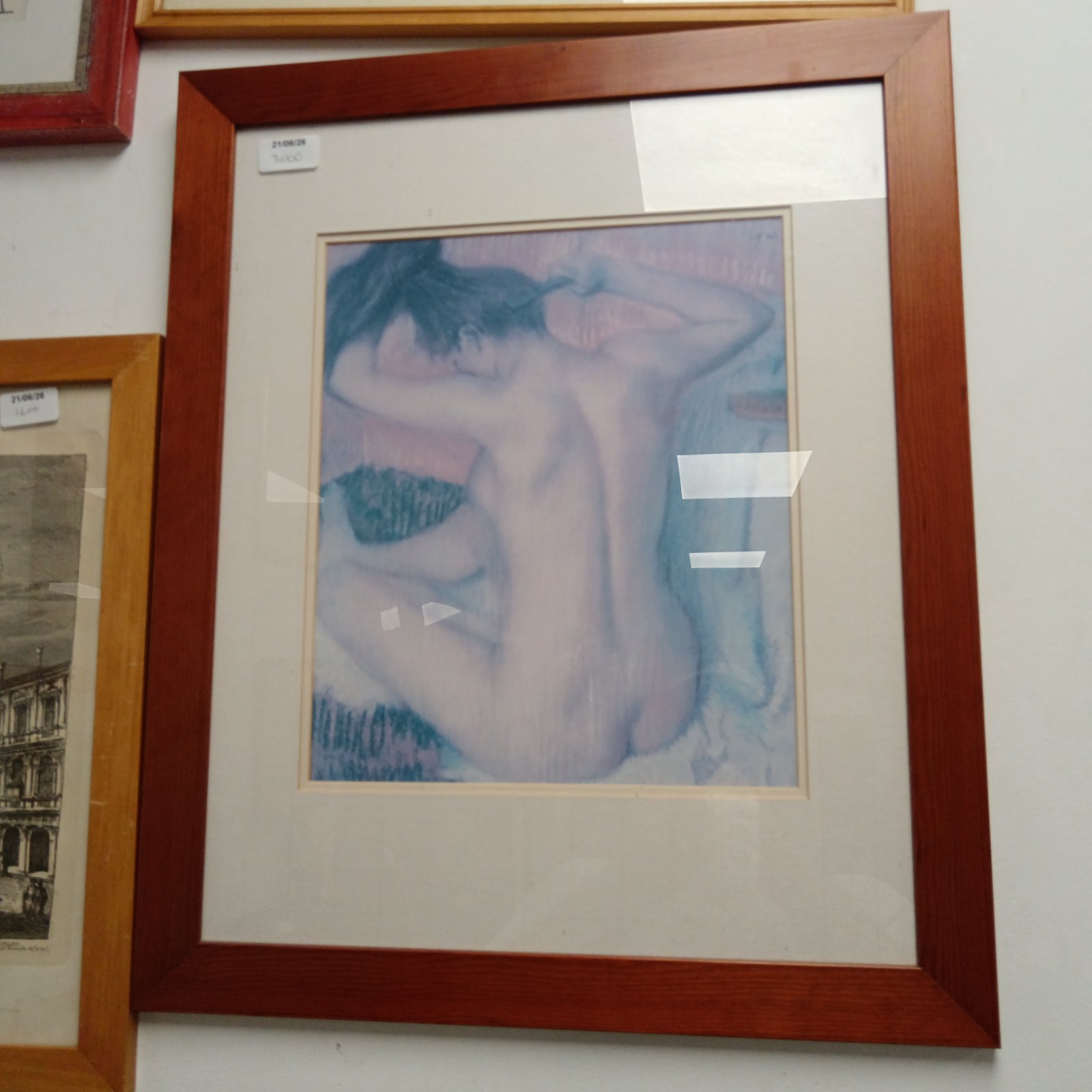 Framed modern print of a nude female figure, contemporary wall art.