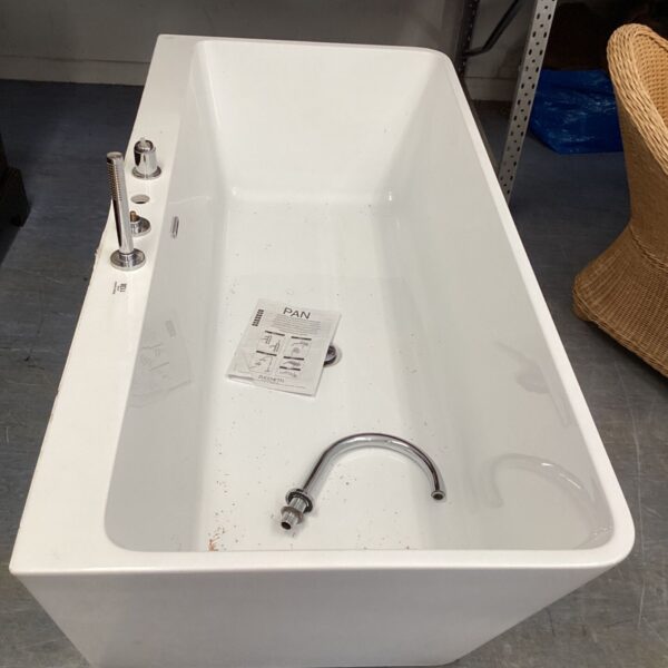 White modern freestanding bathtub with chrome fixtures in a bathroom setting.