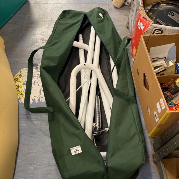 Freestanding metal hammock frame in a green carry bag.