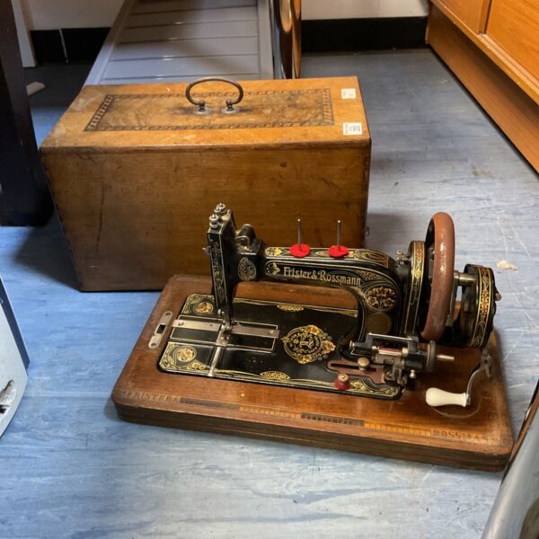 Antique Frister Rossmann hand crank sewing machine with wooden case.