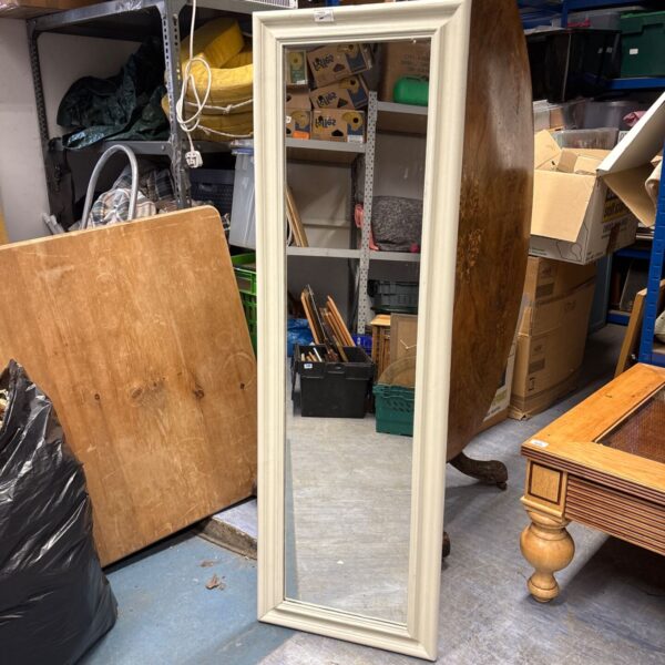 Antique full length mirror with ornate gilded frame.