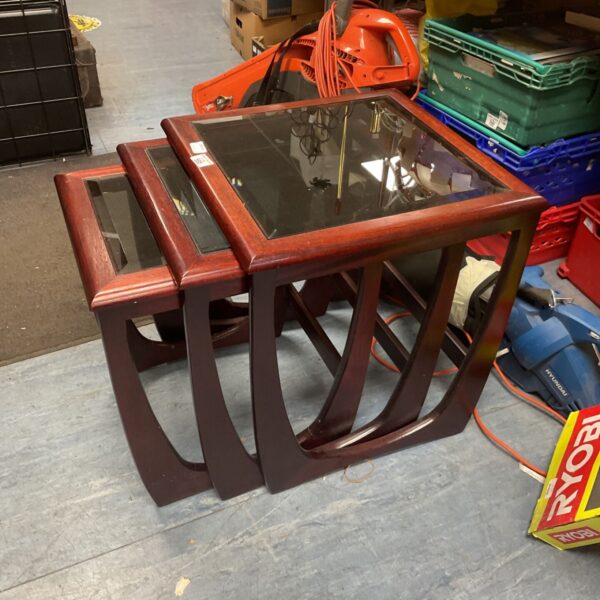 Vintage G Plan Astro nesting tables with teak frames and glass tops.