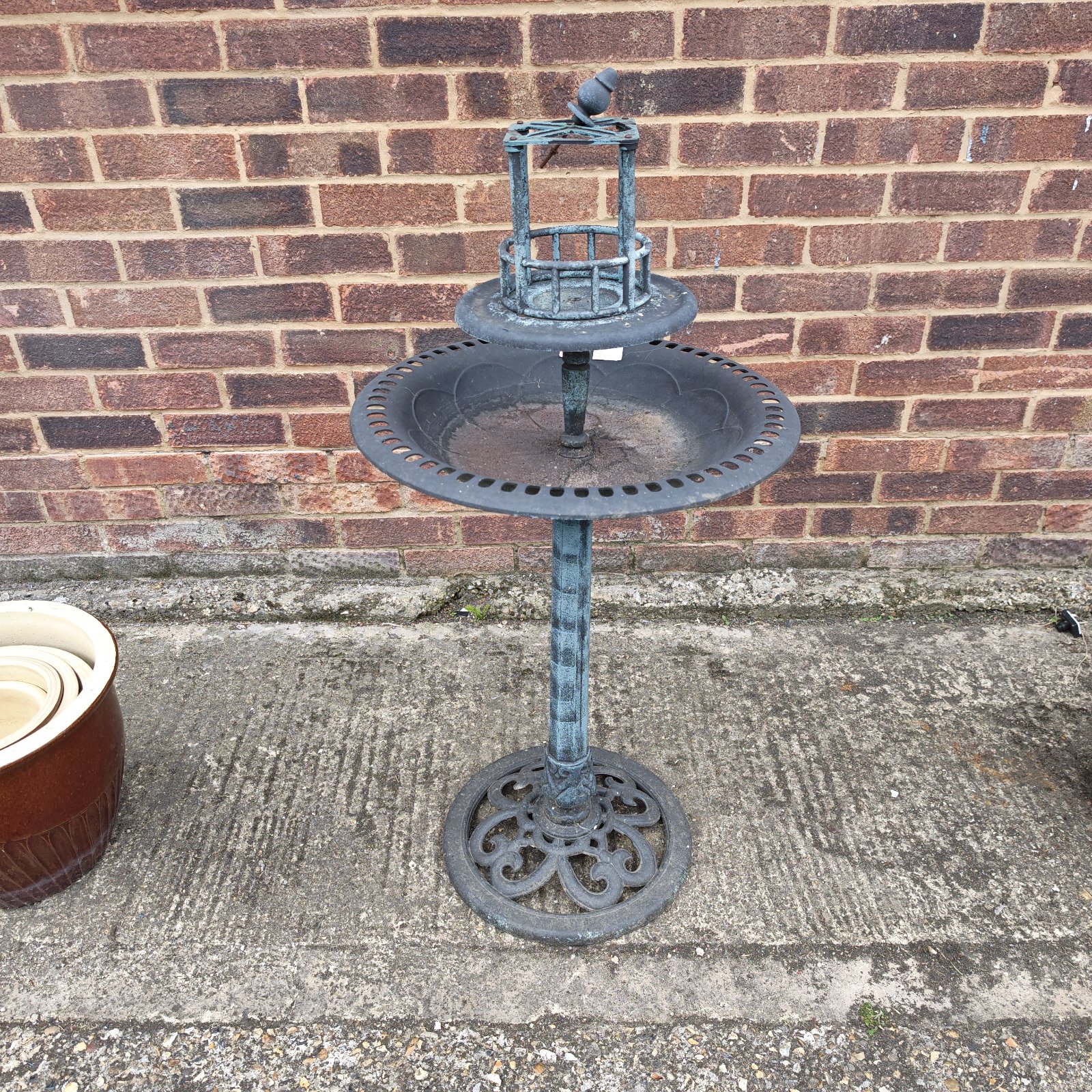Vintage cast iron garden bird feeder with plastic feeder.
