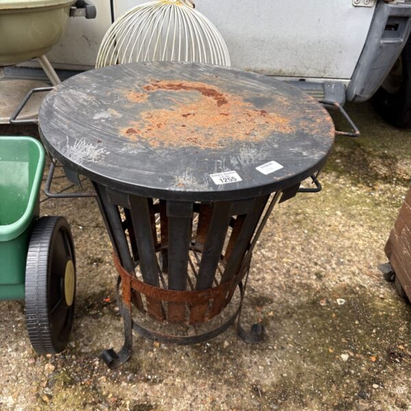 Black steel garden fire pit basket for outdoor use.