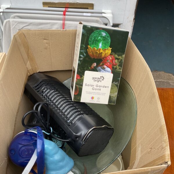 Box of mixed garden solar lights for outdoor illumination.