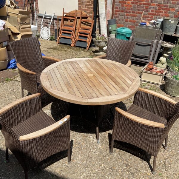 Rustic garden table and chairs set in a weathered condition.