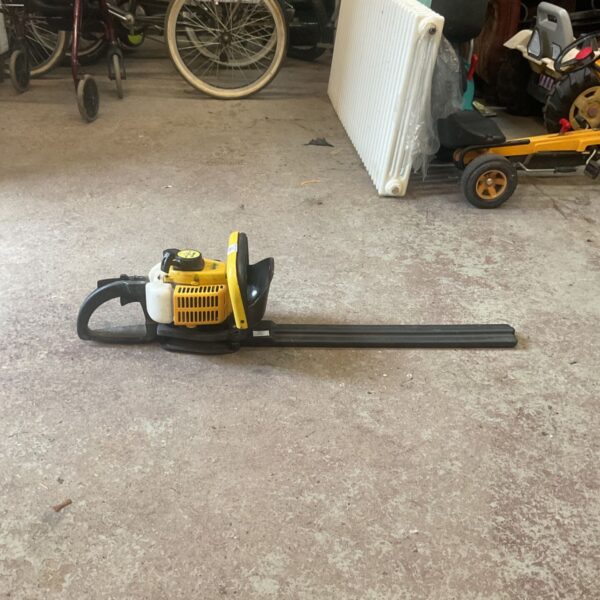 Used gasoline hedge trimmer for garden landscaping and maintenance.