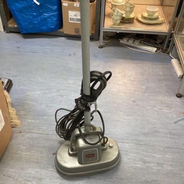 Vintage G&C floor polisher with a worn exterior and power cable.