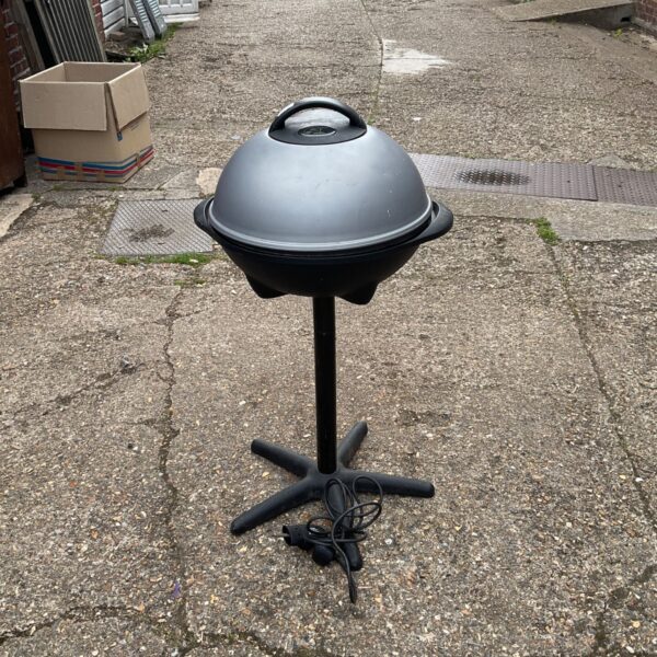 Used George Foreman electric grill with tripod base.