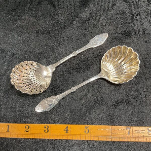 Antique German silver caddy spoons, late 19th century, with pierced strainer bowl.