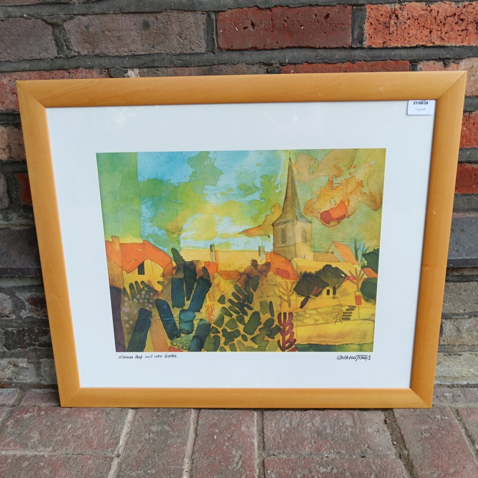 Framed vintage German townscape print with colourful buildings and church.