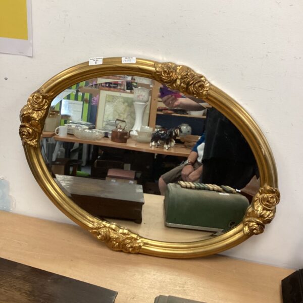 Antique gilt edge bevel mirror with ornate gold frame.