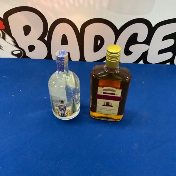Vintage gin and amaretto bottles displayed on a surface.