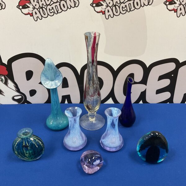 Collection of colourful art glass vases and paperweights for collectors.