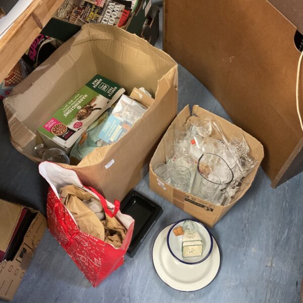 Mixed lot of glassware including wine glasses and plates.
