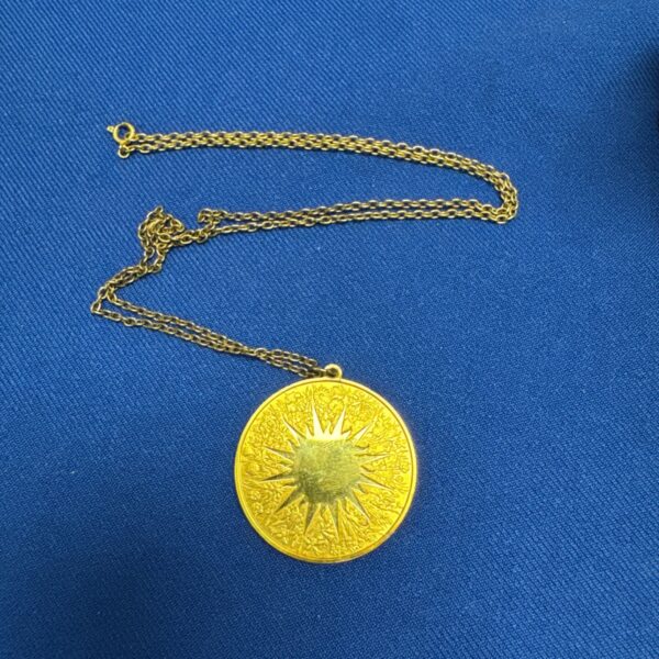 Gold plated silver pendant necklace with sun design.