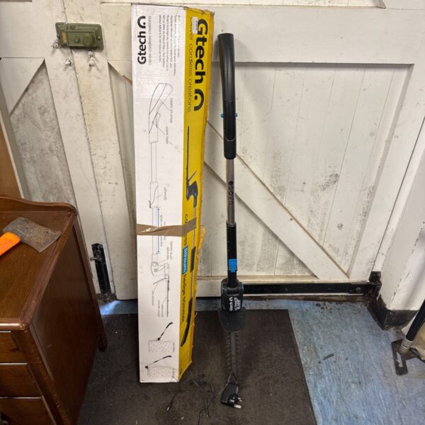 Gtech Ultimate Blade cordless pole hedge cutter with charger.