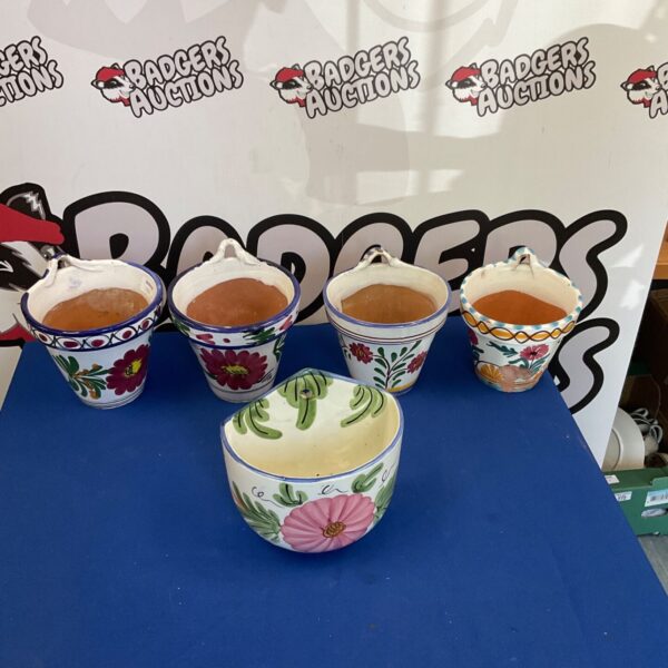 Set of three colourful hand painted flower pots for garden plants.