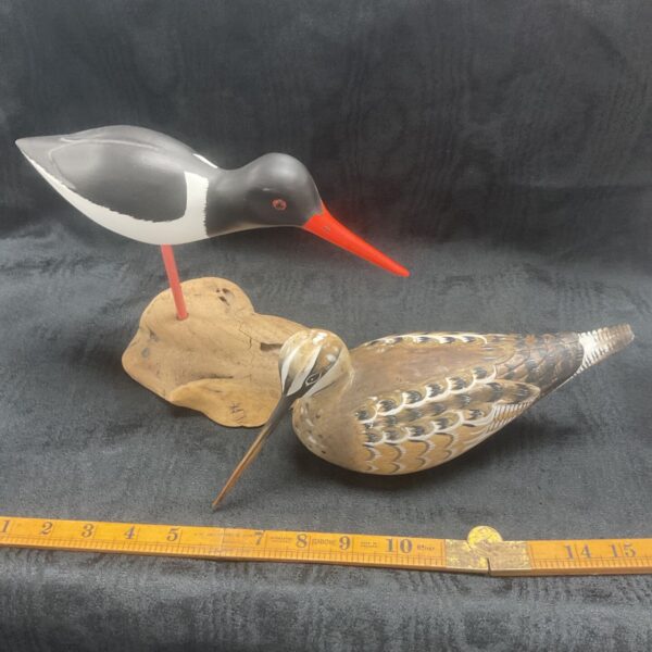 Detailed hand-painted wood bird sculpture, a charming folk art piece.