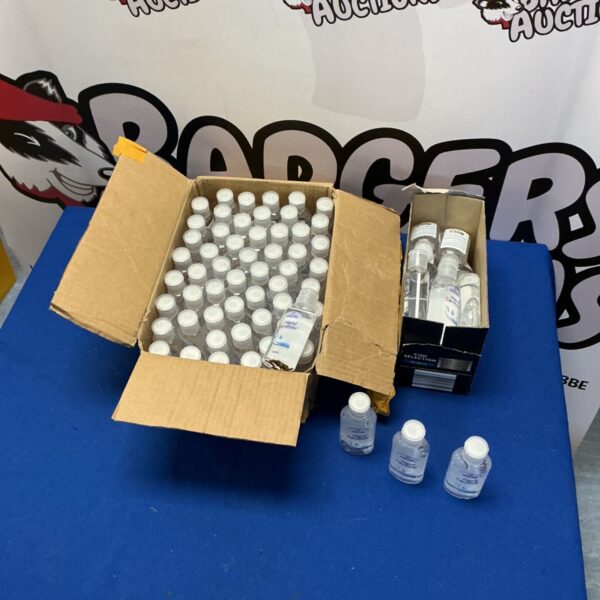 Bulk lot of hand sanitizer bottles in a cardboard box.