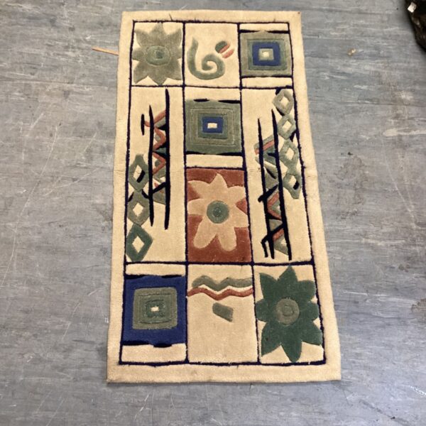 Vintage harlequin rug with geometric pattern and muted colours.