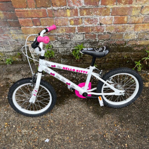 Side view of a pink Hello Kitty children's bicycle.