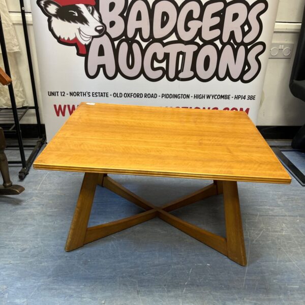 Vintage Mid Century Modern coffee table with blonde wood top and X-base.