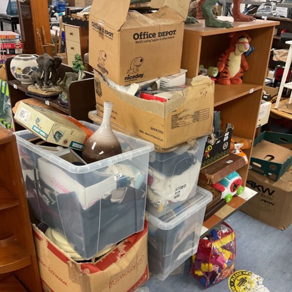 House clearance lot with storage boxes and shoes visible.