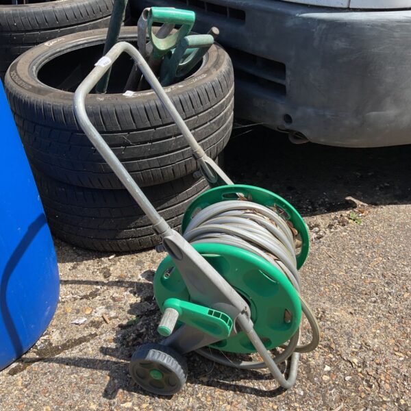 Used Hozelock hose reel in a garden setting.