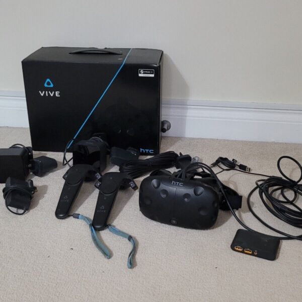 HTC Vive VR kit with headset, controllers, and lighthouses.