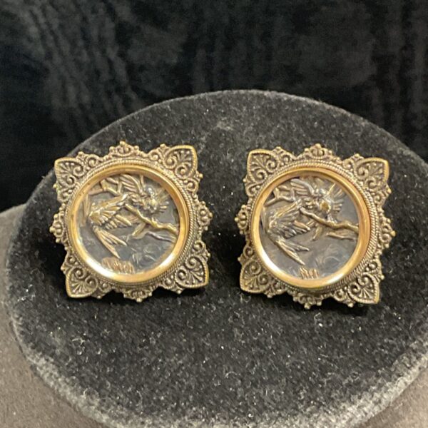 Vintage hummingbird cufflinks pair on display.