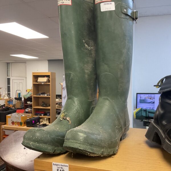 Green Hunter Wellington boots showing signs of wear.