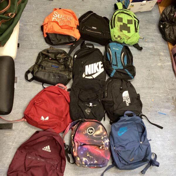 A box of rucksacks inc Adidas north face hype super dry snd pretty little thing